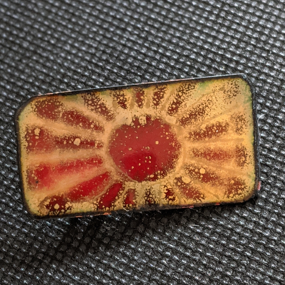 Handcrafted Enameled Brooch with Red Sunburst